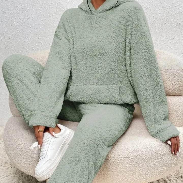 Woman modeling a plush women's loungewear set. Warm hoodie & pants for ultimate comfort and casual style.