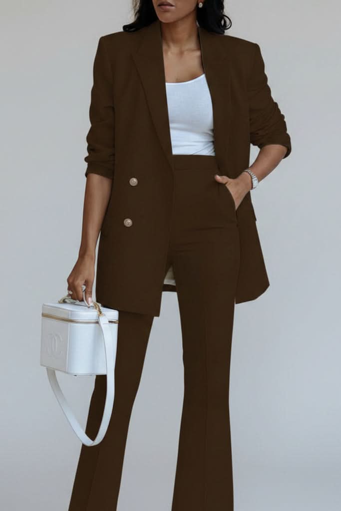 Woman models a sleek women's suit set with blazer & trousers, perfect for elegant office wear.