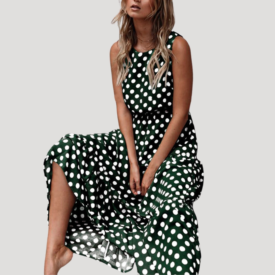 Versatile women's sleeveless polka dot midi dress. A-line, flowy, and casual, great for summer or vacation.