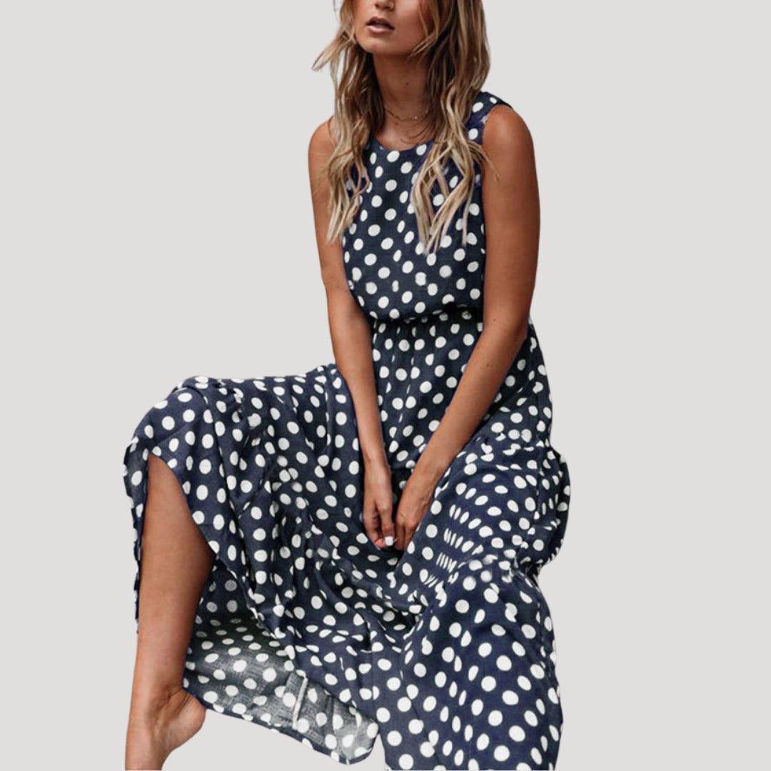 Chic women's polka dot sleeveless A-line midi dress. Flowy design for a comfortable, stylish summer casual look.