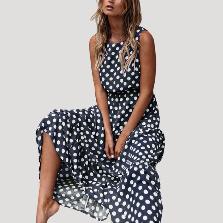 Chic women's polka dot sleeveless A-line midi dress. Flowy design for a comfortable, stylish summer casual look.