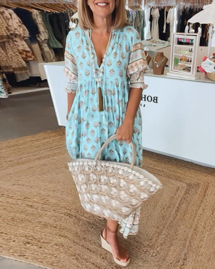Women's printed bohemian midi dress with lantern sleeves and V-neck.