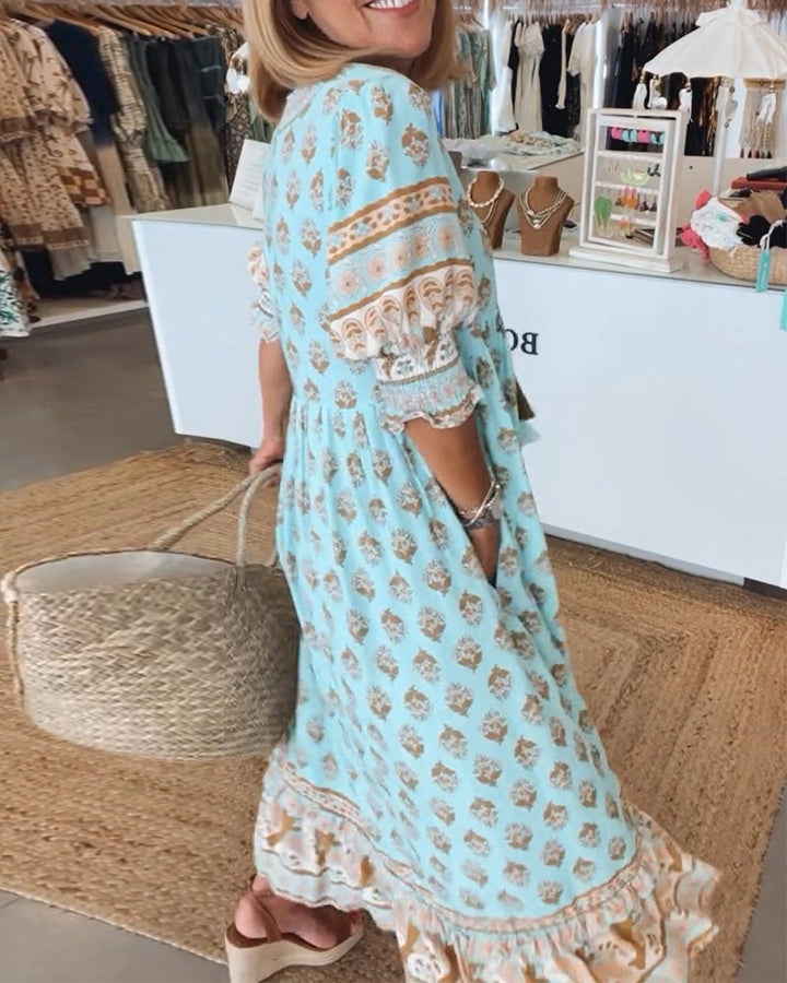Flowy bohemian women's midi dress with vibrant print & elegant lantern sleeves for summer.