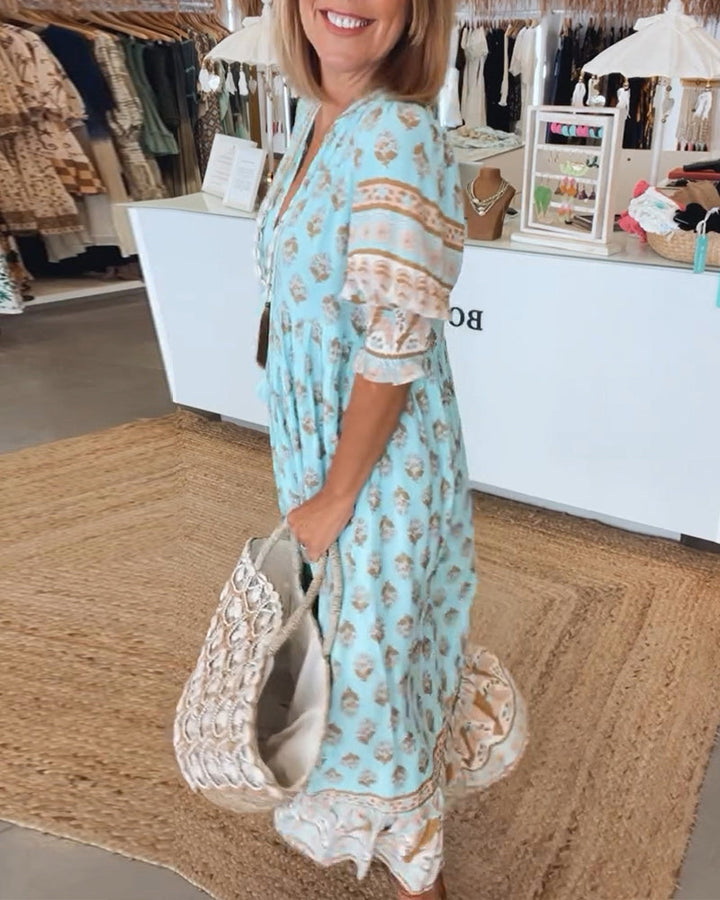 Elegant women's bohemian midi dress with a beautiful print, loose fit, and convenient pockets.