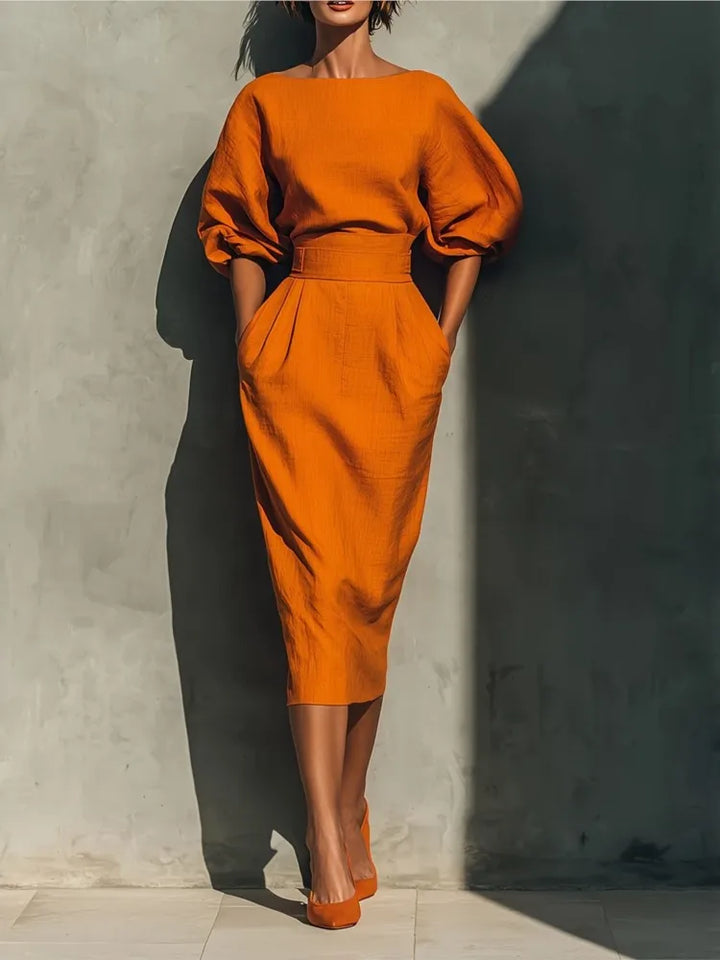 Women's puff sleeve midi dress with practical pockets, perfect for elegant casual wear.