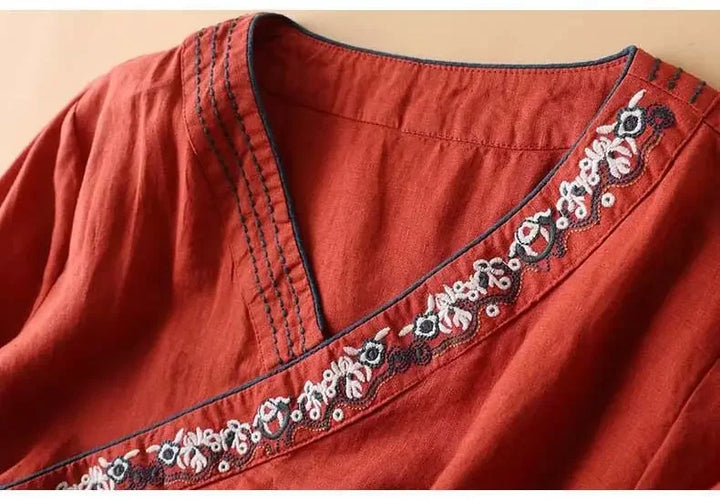 Relaxed fit women's red blouse, chic pattern, V-neck, elegant embroidery.
