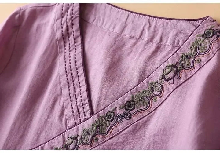 Casual chic pink women's top, patterned, embroidered, relaxed V-neck fit.