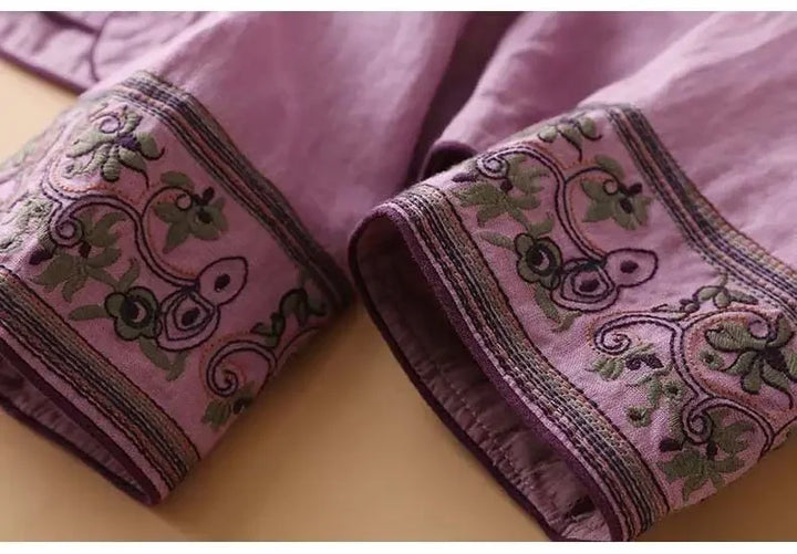 Red patterned V-neck blouse, women's relaxed fit, elegant embroidered detail.