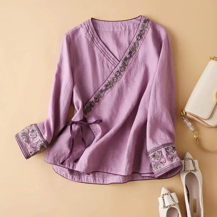 Red women's relaxed fit blouse with intricate embroidery and chic pattern.
