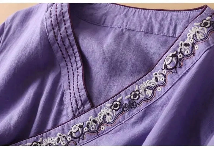 Stylish navy blue patterned V-neck blouse, women's relaxed fit.
