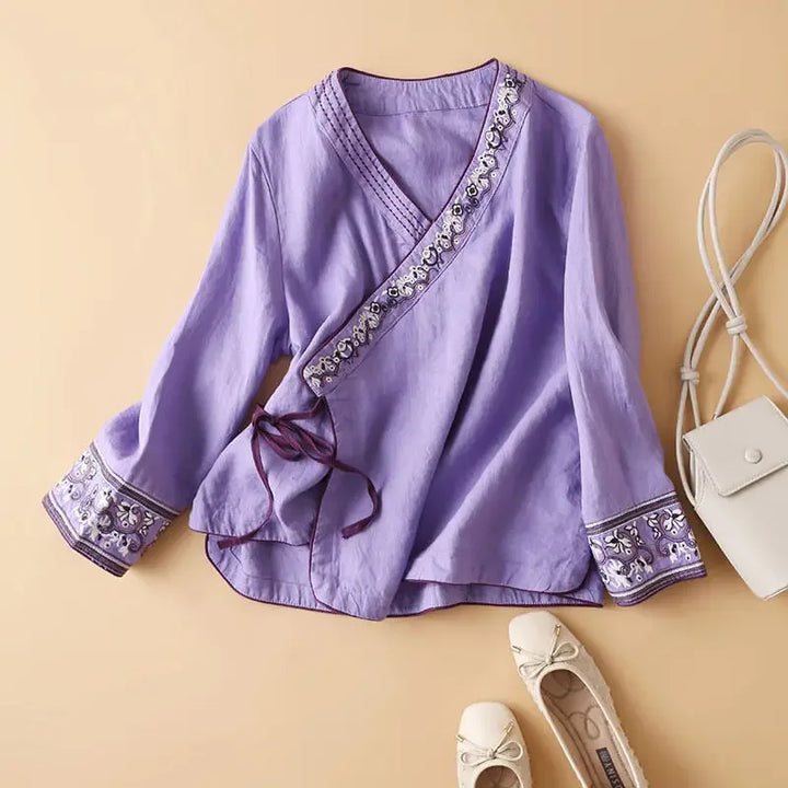 Elegant women's blouse, patterned with embroidery, relaxed fit V-neck.