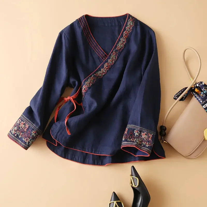 Chic red V-neck blouse, relaxed fit, detailed pattern & elegant embroidery.