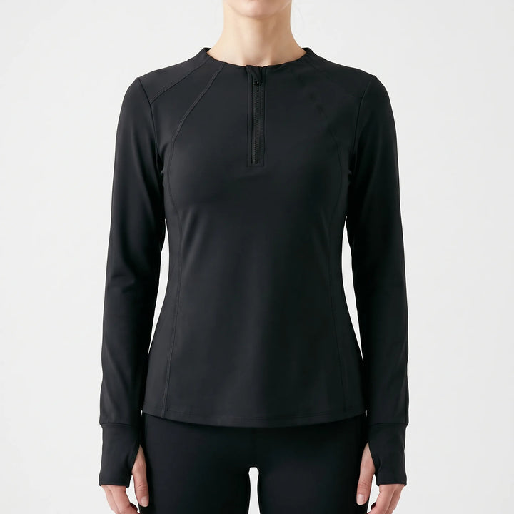 Female model wearing a quarter-zip long sleeve workout top, ideal athletic wear for fitness.
