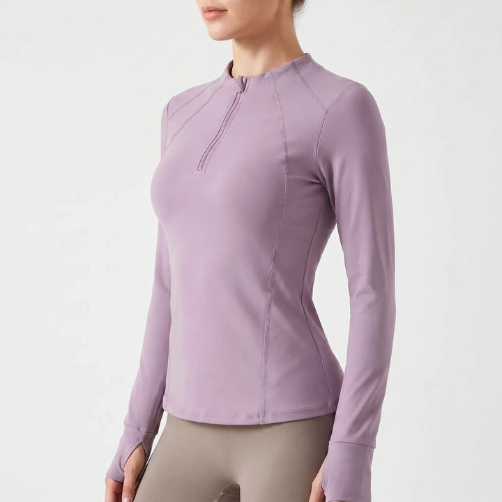 Close-up of the quarter-zip detail on a women's long sleeve sports top, essential for training gear.