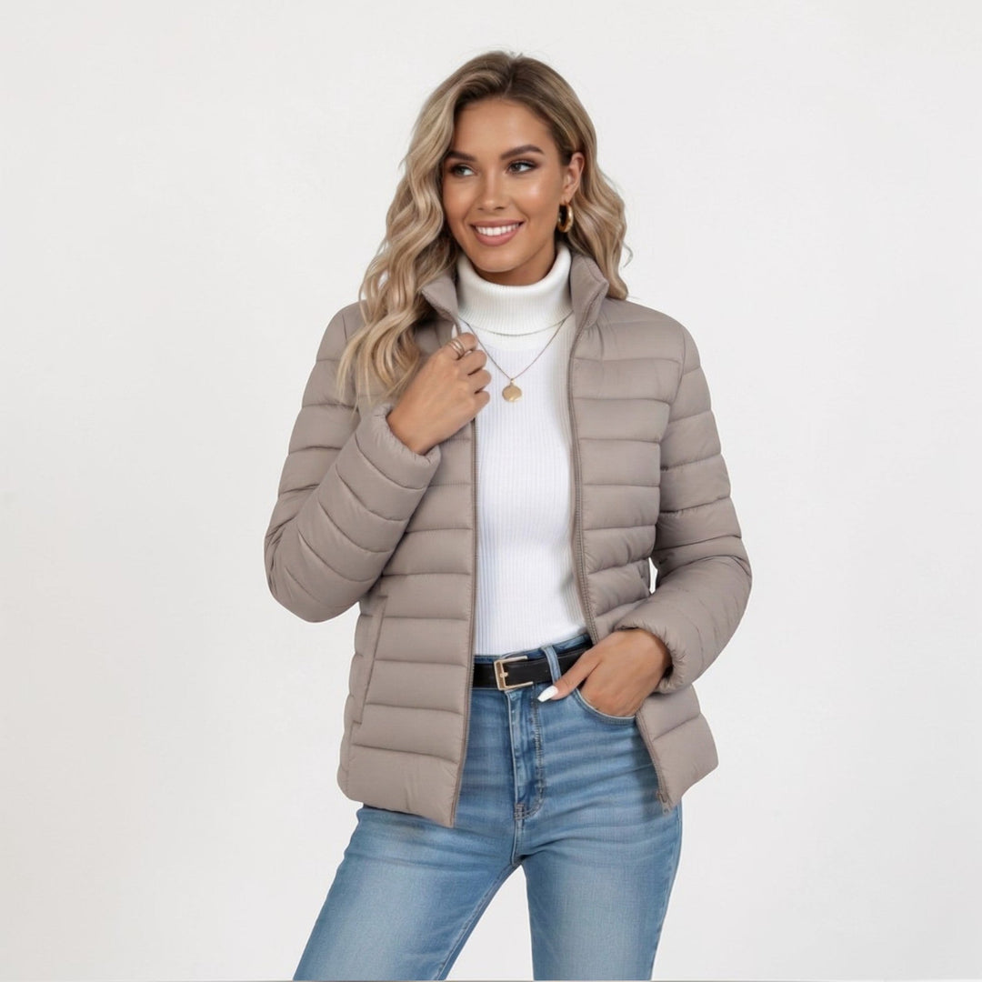 Women's quilted jacket with stand collar & full zip closure, ideal for fall & winter casual wear.