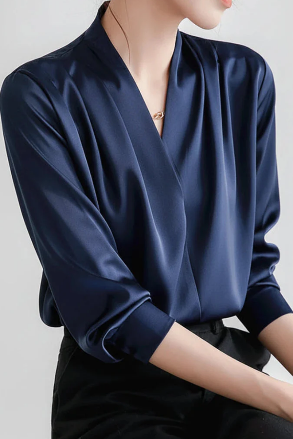 Stylish women's wrap top. This elegant long sleeve blouse offers a refined look for everyday, casual chic or workwear.