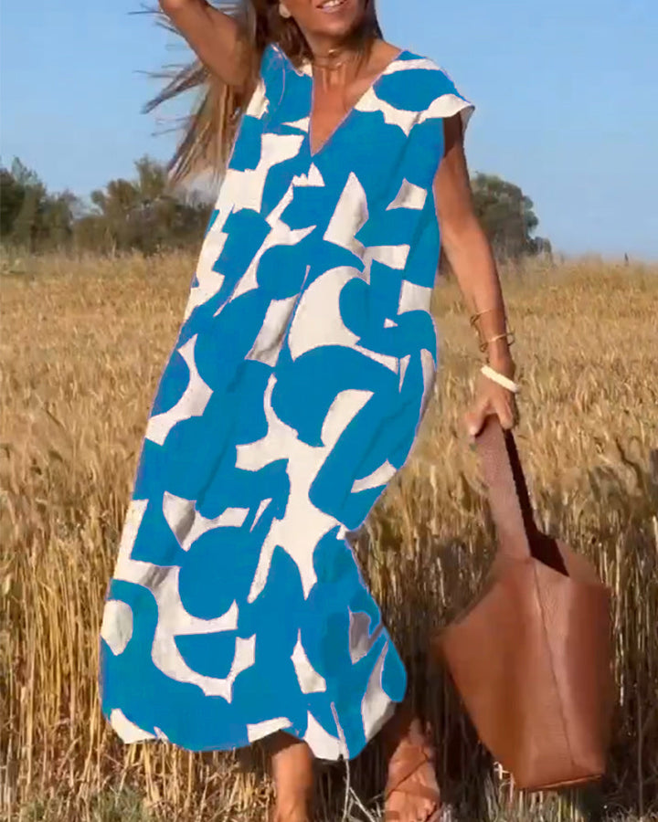 Comfortable women's loose fit V-neck dress, abstract print, ideal for relaxed summer fashion.