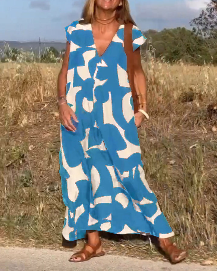 Women's summer fashion: relaxed V-neck abstract print dress, versatile for various occasions.