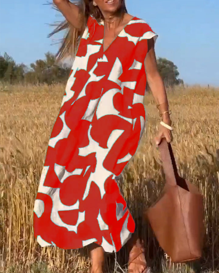 Trendy women's abstract print relaxed dress, V-neck, an easy-to-wear summer statement piece.