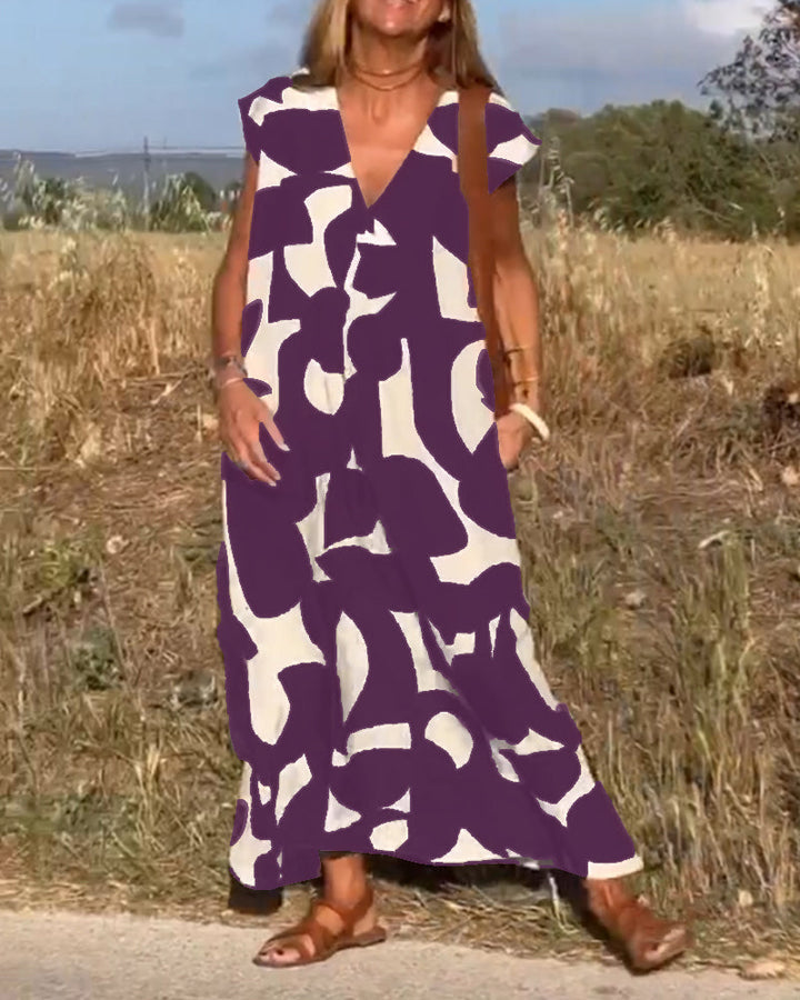 Chic women's relaxed abstract print dress, V-neck, perfect for a casual yet refined summer look.