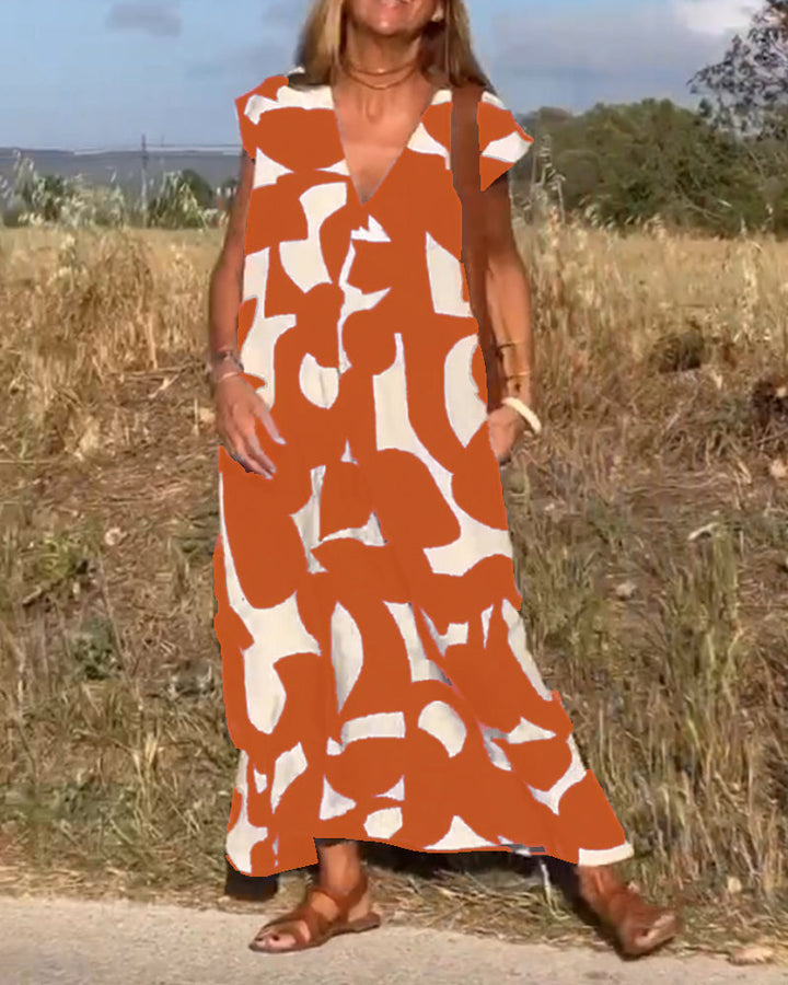 Women's loose fit V-neck abstract print dress, relaxed, ideal for comfortable summer vacation style.