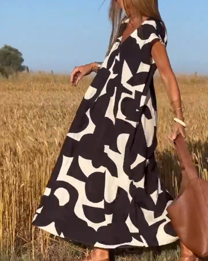Vibrant abstract print casual dress for women, relaxed fit, ideal for summer vacation outfits.