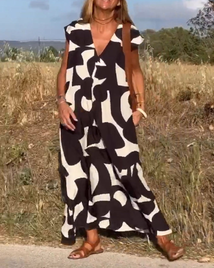 Women's vacation wear: relaxed abstract print dress, V-neck, comfortable & chic for summer.