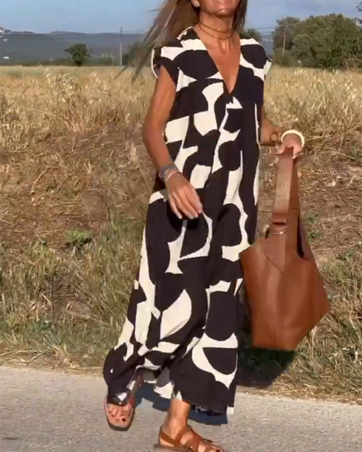Flowy women's abstract print dress, relaxed V-neck, perfect for a vibrant summer casual look.