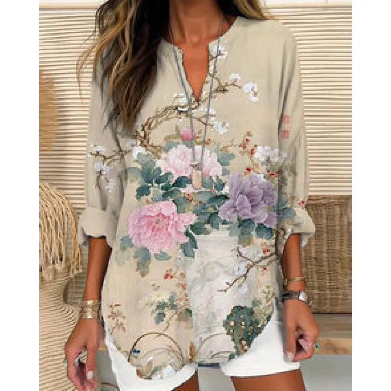 Elegant women's blouse showcasing a unique split neck design and folded three-quarter cuffs, in a relaxed fit.
