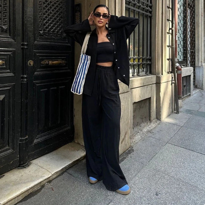 Model wearing women's relaxed fit button down shirt & wide leg pants set, showcasing comfortable summer style.