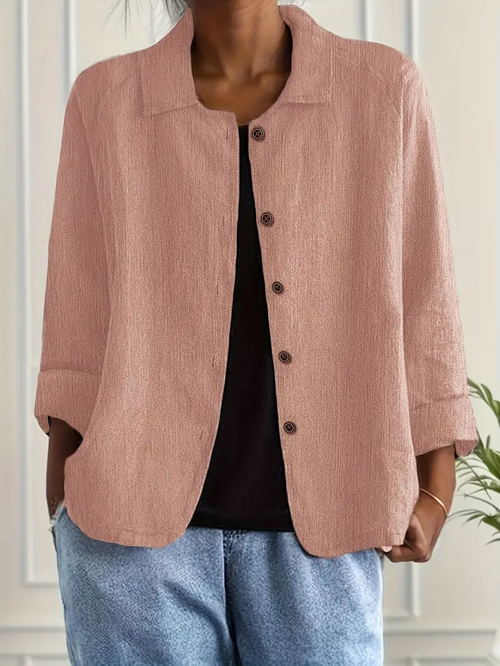 Stylish women's collared button-front top with three-quarter sleeves & relaxed fit for casual wear.