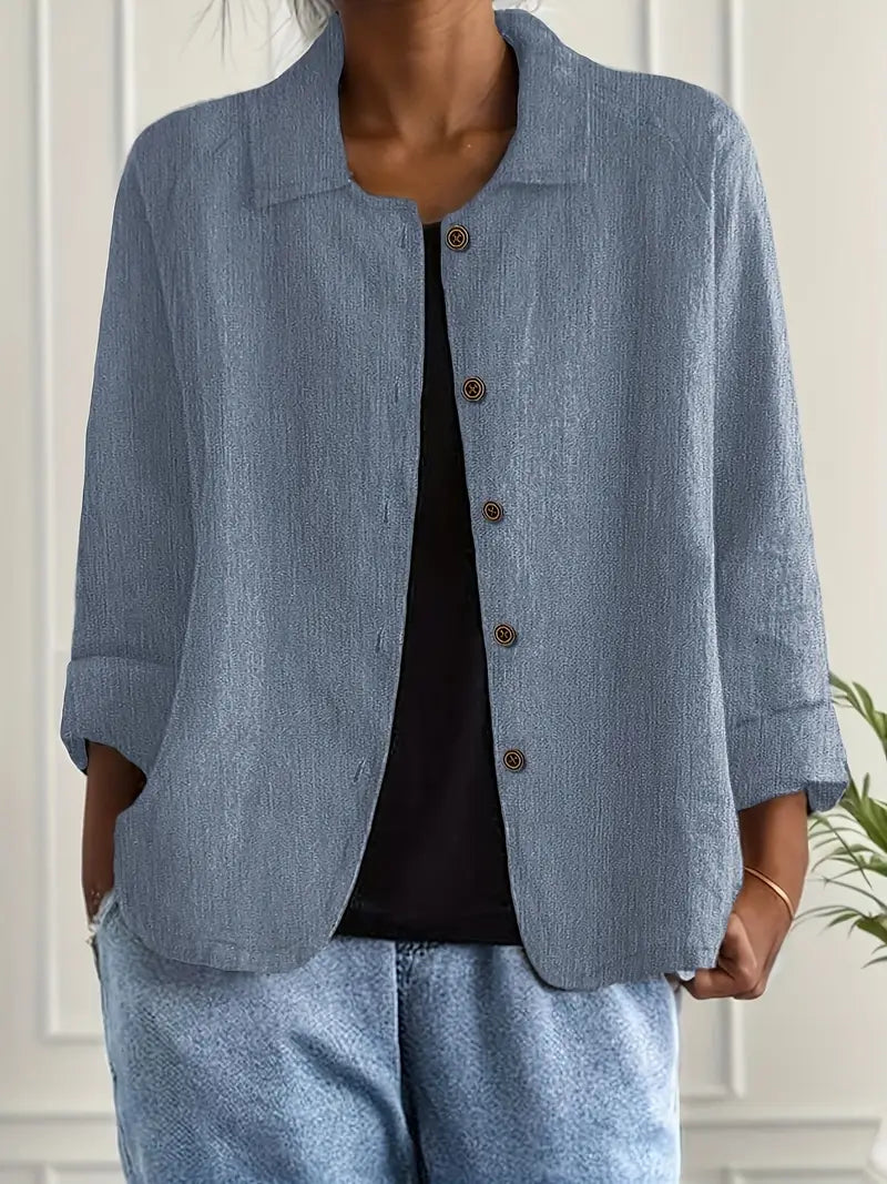 Fashionable women's relaxed fit spring/summer top, button-front, 3/4 sleeves, perfect for warm days.