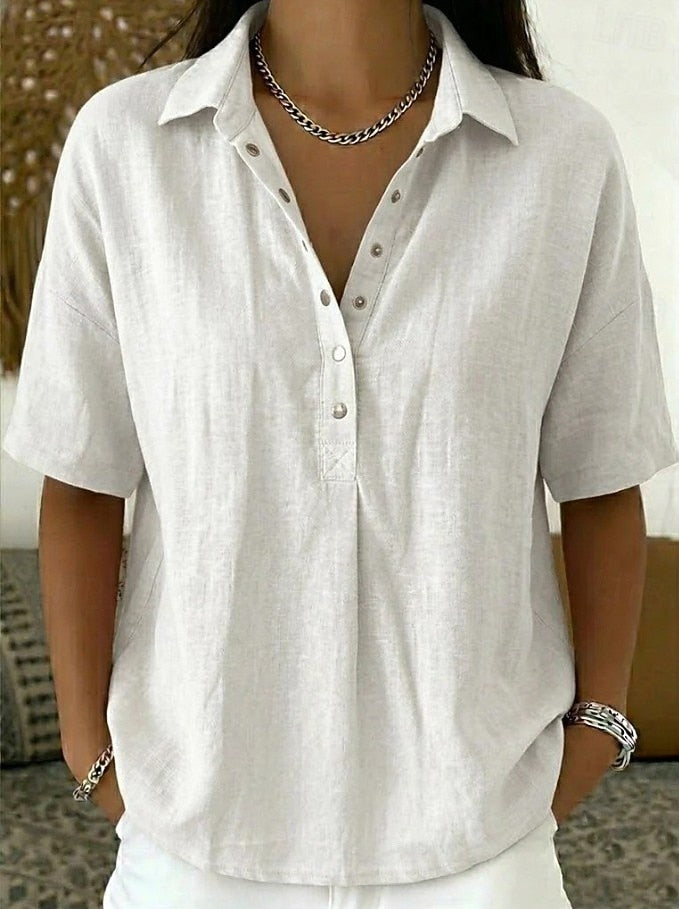 Classic women's relaxed fit collar shirt. Features front button details, ideal for a chic, casual ensemble.
