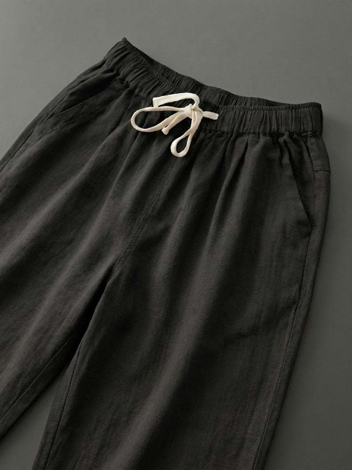 Relaxed fit women's pants with an elastic waist and stylish cuffed hem.