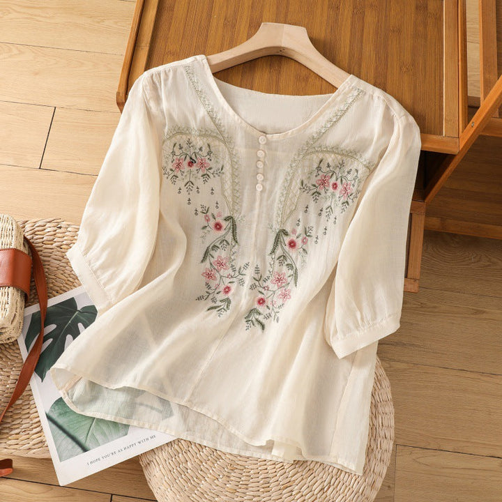 Elegant women's floral embroidered V-neck blouse. Relaxed long sleeve top, ideal for versatile spring casual wear.