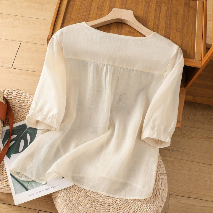 Comfortable women's relaxed fit blouse. Features delicate floral embroidery, V-neck, long sleeves, great for everyday style.