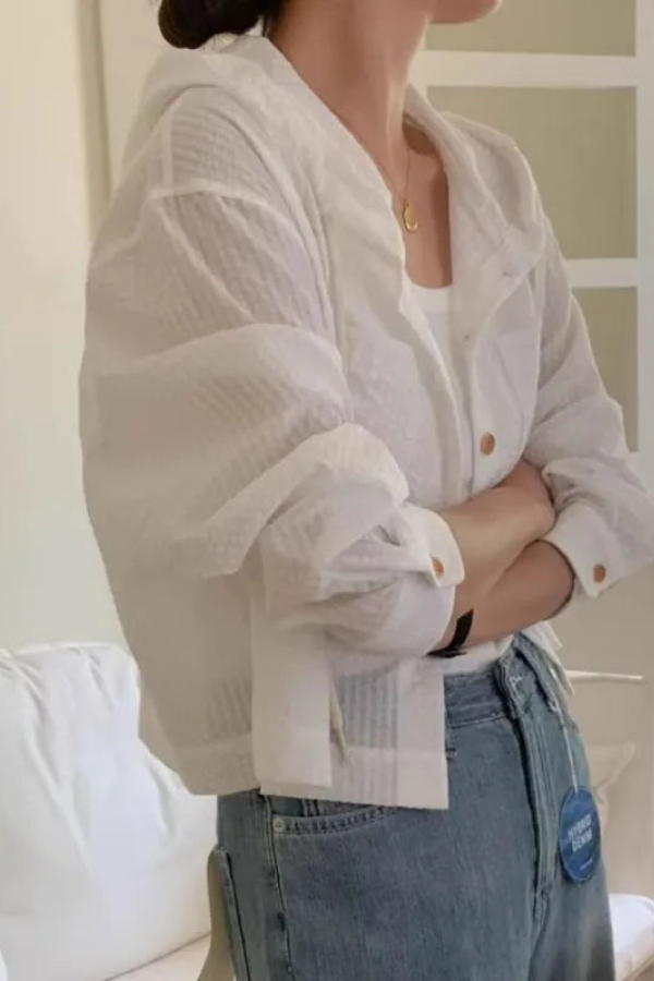 Effortless women's summer blouse with a relaxed fit and practical hood. Versatile long sleeve top.