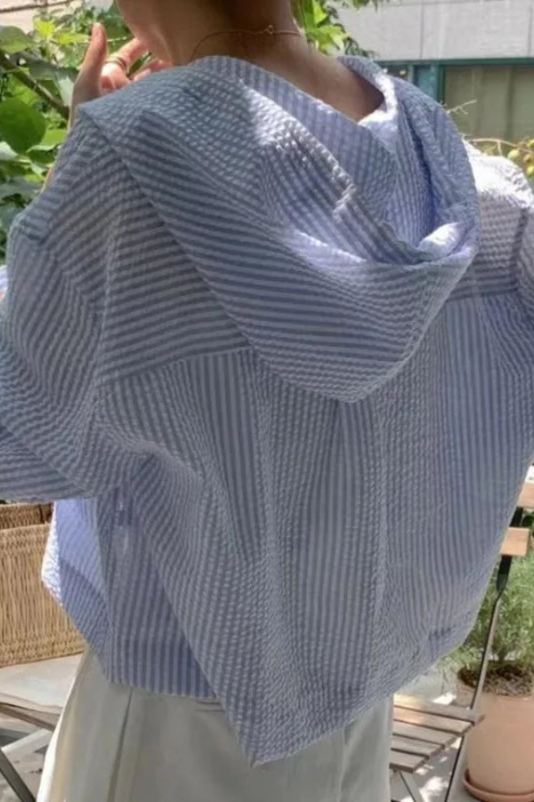 Lightweight women's relaxed hooded blouse. Stylish long sleeve top for versatile summer outfits.