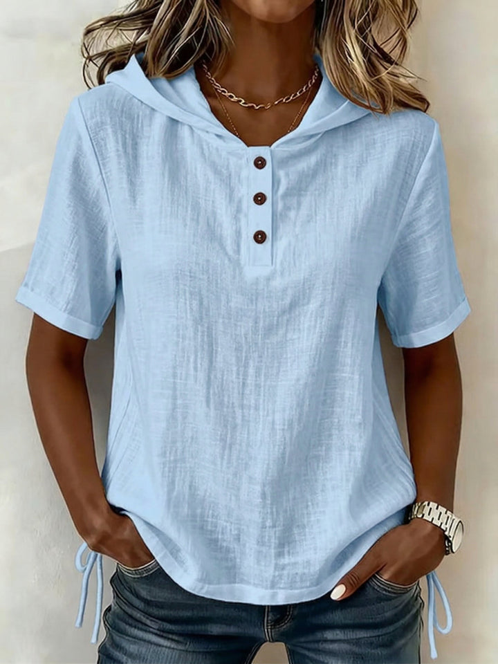 Comfortable women's hooded button-up shirt, relaxed fit, great for versatile everyday looks.