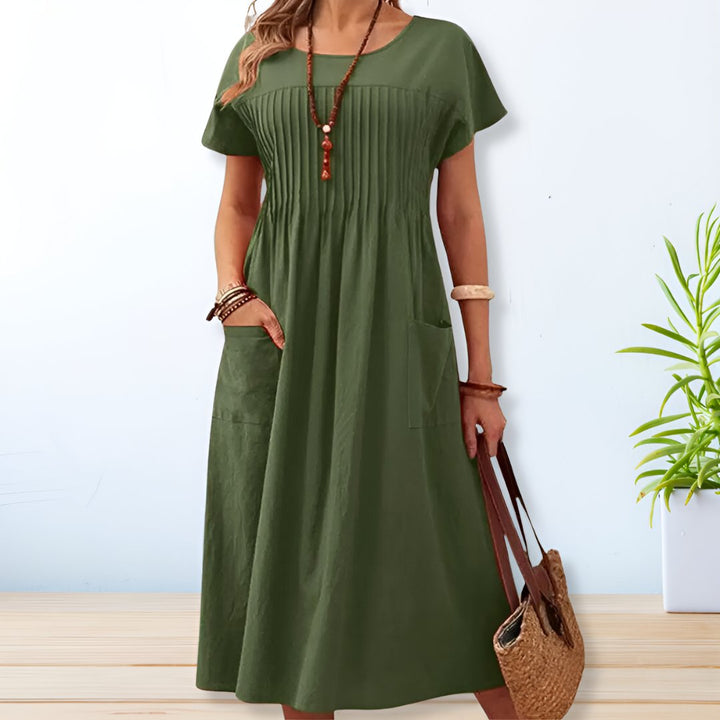 Stylish women's relaxed fit short sleeve midi dress with pockets. Versatile casual day dress for summer fashion.