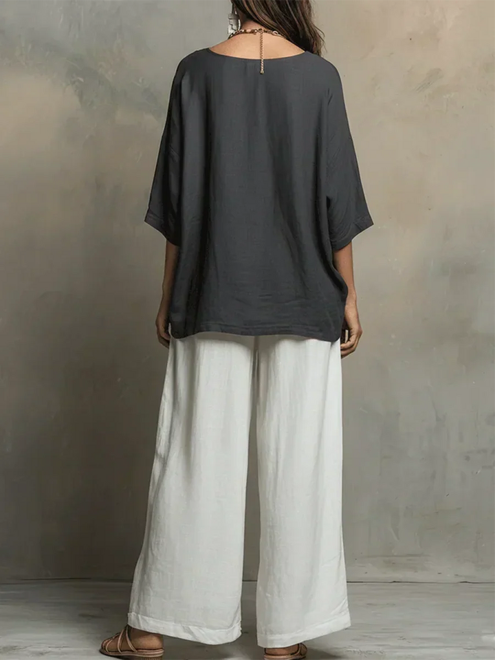 Woman models a relaxed fit shirt & wide leg pants matching set, showcasing comfortable everyday summer style.