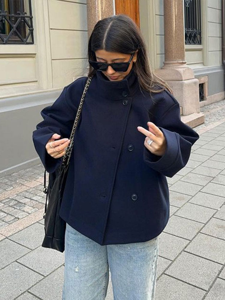 Chic women's short coat, relaxed fit for comfort. Features a high neck & classic button closure for fall/winter.