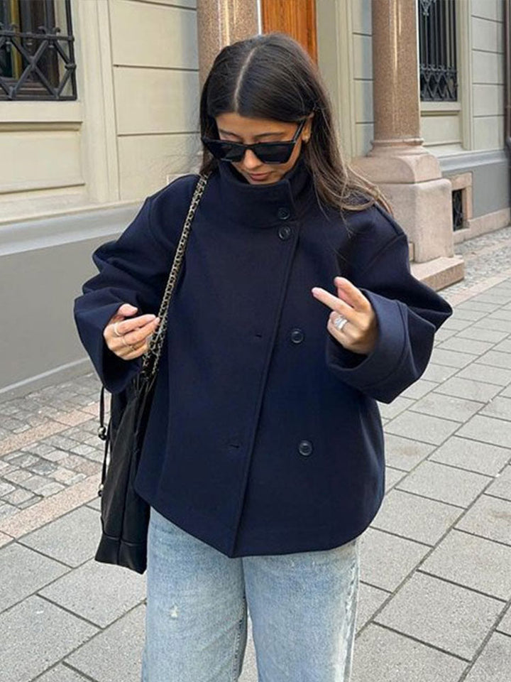 Chic women's short coat, relaxed fit for comfort. Features a high neck & classic button closure for fall/winter.