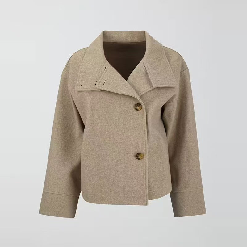 Modern women's short coat featuring a relaxed fit, high neck, and button closure. Essential outerwear for winter style.