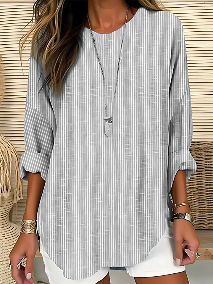 Comfortable women's relaxed fit long sleeve blouse featuring classic stripes. Ideal for chic and effortless casual wear.