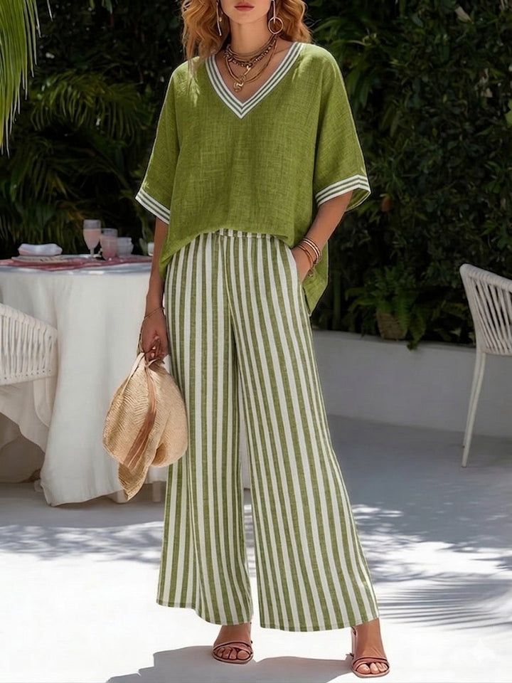 Cozy women's striped two-piece loungewear set with a relaxed fit V-neck shirt and comfortable wide leg pants.