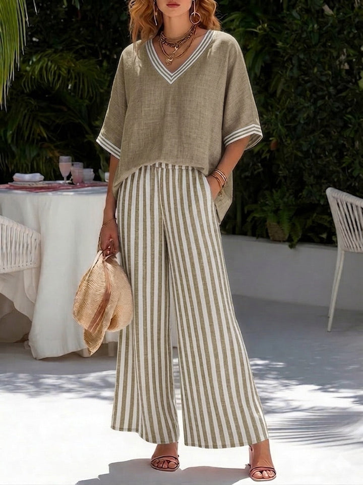 Modern women's striped matching two-piece set featuring a relaxed shirt and wide-leg pants, perfect for summer.