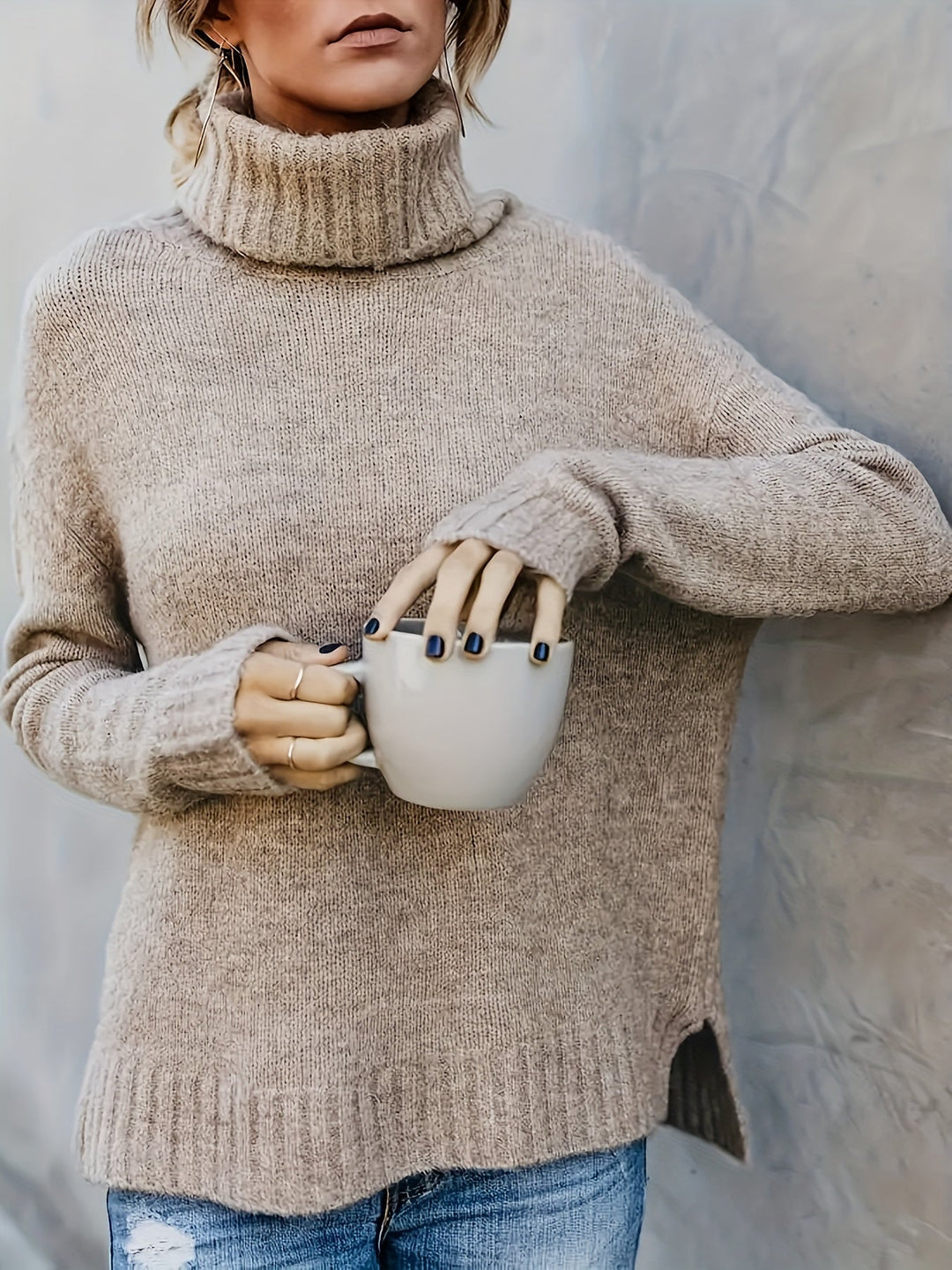 Versatile women's turtleneck sweater with a relaxed silhouette and fashionable side split hem.