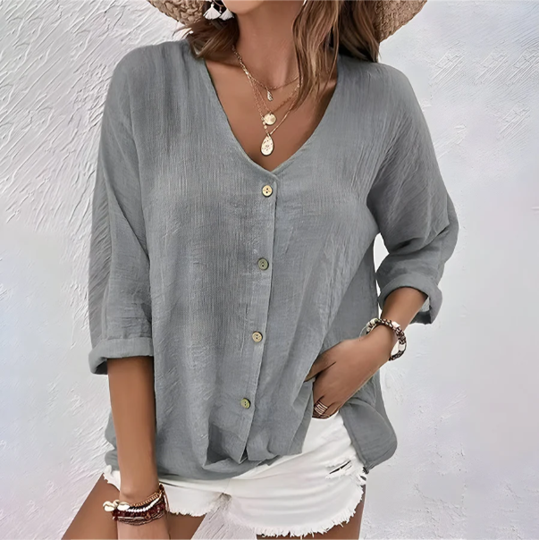 Comfortable relaxed fit women's V-neck top with versatile roll sleeves and button-up front.