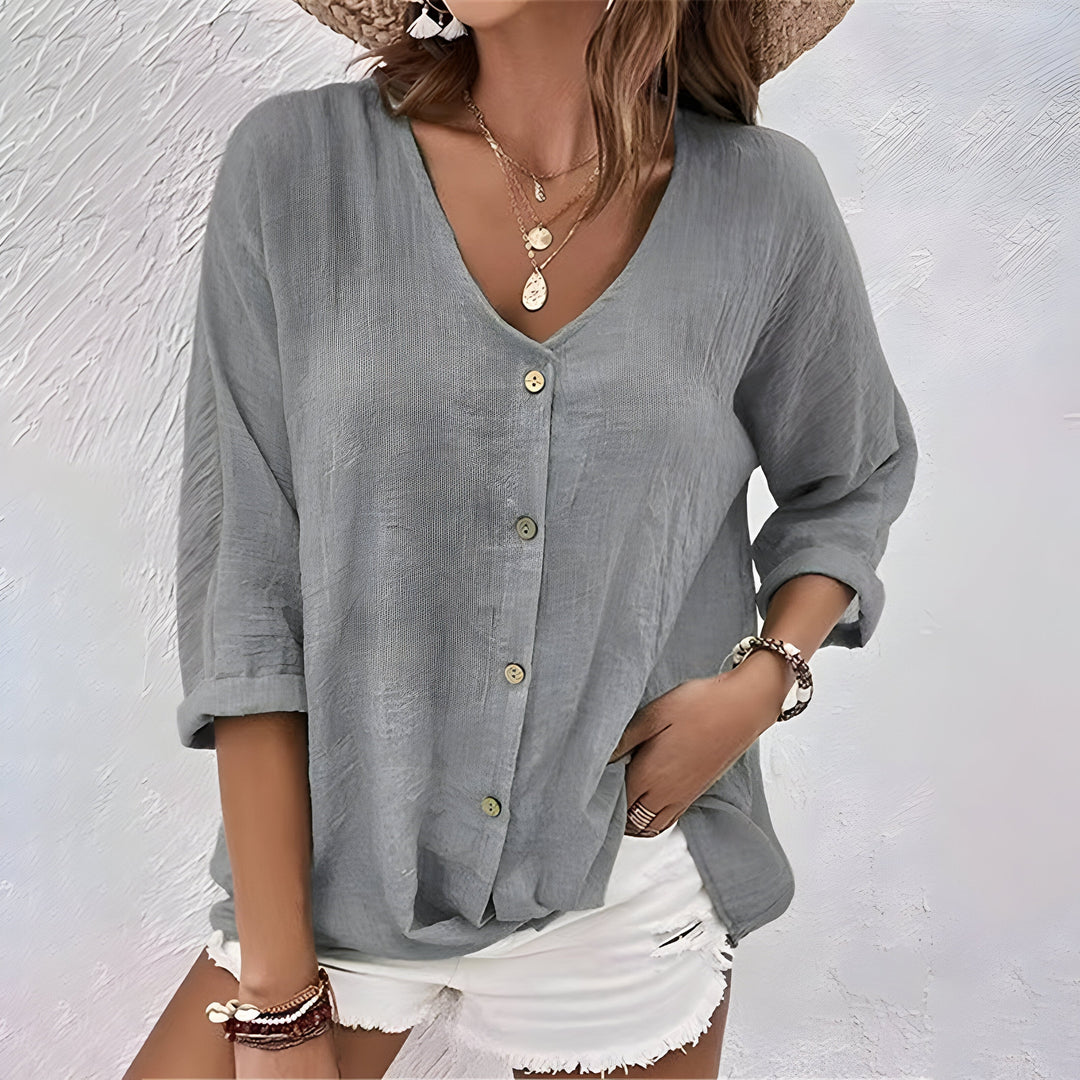 Versatile long sleeve women's blouse, relaxed V-neck, button front, and roll-up sleeves for any occasion.